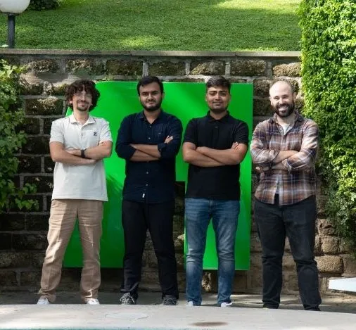 Four Pi School fellows posing outdoors beside a pool